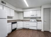 Thumbnail 5 of 13 - a kitchen with white cabinets and white appliances  at Rosillo Creek Apartments, San Antonio, TX