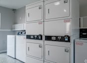 Thumbnail 20 of 23 - Row of white washing machines in a laundromat at Brook Meadow Village, Austin, Texas