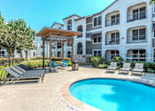 Thumbnail 34 of 36 - A pool area with a sun lounger and a table at Rosemary Apartments, Texas, 77384