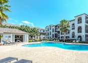 Thumbnail 26 of 36 - A swimming pool in front of a row of apartment buildings at Rosemary Apartments, Texas