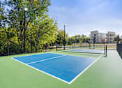 Thumbnail 18 of 72 - the preserve at ballantyne commons tennis court with apartments in the background at Radius on Grove, Austin