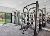 Thumbnail 36 of 72 - a gym with weights and cardio equipment at the preserve at greatstone at Radius on Grove, Austin