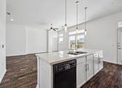 Thumbnail 26 of 72 - an open kitchen and living room with white walls and white counter tops and a sink at Radius on Grove, Austin, 78741