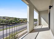 Thumbnail 29 of 72 - the view from the balcony of a condo with a balcony railing and a street at Radius on Grove, Texas