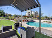 Thumbnail 31 of 72 - a backyard with a pool and patio with chairs and a canopy at Radius on Grove, Texas, 78741