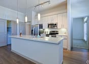 Thumbnail 70 of 72 - A kitchen with a white island and a refrigeratorat Radius on Grove, Austin, 78741