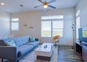 Thumbnail 3 of 72 - Living room with grey couchat Radius on Grove, TX, 78741