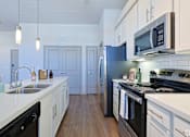 Thumbnail 69 of 72 - A kitchen with black appliances and white cabinetsat Radius on Grove, Austin, TX