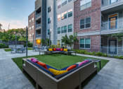 Thumbnail 1 of 37 - an outdoor lounge area at the bradley braddock road station apartments at Republic at Alamo Heights, San Antonio Texas