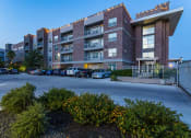 Thumbnail 37 of 37 - a large brick building with a parking lot in front of it at Republic at Alamo Heights, San Antonio, TX