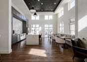 Thumbnail 6 of 25 - a large living room with a kitchen and a dining room at The Fitzroy San Marcos, San Marcos, TX