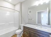 Thumbnail 24 of 25 - a bathroom with a sink toilet and a mirror at The Fitzroy San Marcos, San Marcos, Texas
