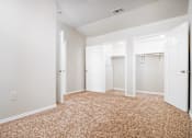 Thumbnail 21 of 35 - Spacious bedroom with dual walk-in closets at Houston Street Townhomes Apartments, San Antonio, Texas