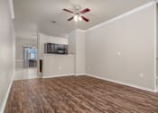 Thumbnail 34 of 35 - Open living area with wood style flooring at Houston Street Townhomes Apartments, Texas