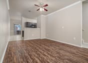 Thumbnail 13 of 35 - Open living and dining area with wood flooring at Houston Street Townhomes Apartments, Texas, 78220