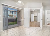 Thumbnail 16 of 35 - Open entryway with tile flooring and patio access at Houston Street Townhomes Apartments, Texas