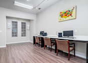 Thumbnail 30 of 35 - Business center with computer workstations at Houston Street Townhomes Apartments, San Antonio, TX