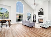 Thumbnail 1 of 35 - Living room with vaulted ceiling and fireplace at Houston Street Townhomes Apartments, San Antonio, TX