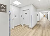 Thumbnail 27 of 29 - A hallway with doors and a sign that says "Area of Refuge".