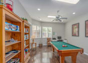 Thumbnail 11 of 11 - A room with a pool table and a bookshelf.
