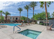 Thumbnail 4 of 11 - A pool surrounded by palm trees and lounge chairs.