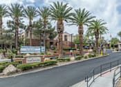 Thumbnail 8 of 11 - A street view of a residential area with palm trees and a sign for Vintage Dentist Boss.