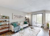 Thumbnail 1 of 35 - a living room with a white couch and a sliding glass door at Runaway Bay Apartments, Columbus, OH, 43204