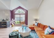 Thumbnail 5 of 24 - community clubroom with orange couch at The Vale Apartments and Townhomes, Tennessee, 38018