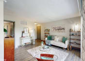 Thumbnail 3 of 35 - a living room with a couch and a table at Runaway Bay Apartments, Ohio
