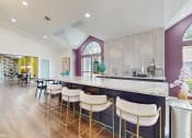Thumbnail 1 of 24 - a kitchen with a long counter with bar stools at The Vale Apartments and Townhomes, Cordova, TN