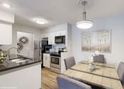 Thumbnail 18 of 46 - an open kitchen and dining room with a table and chairs at Island Club Apartments, Columbus, Ohio