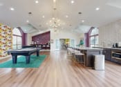 Thumbnail 6 of 24 - a game room with a pool table and a bar at The Vale Apartments and Townhomes, Cordova, TN