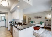 Thumbnail 6 of 35 - an open kitchen and living room with a black counter top at Runaway Bay Apartments, Columbus, 43204