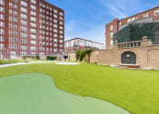 Thumbnail 12 of 25 - a putting green in the middle of a building at 275 on the Park Apartments, St. Louis, MO, 63108