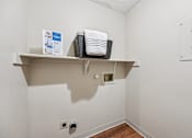 Thumbnail 13 of 24 - A white shelf with a basket and towels on it.