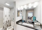 Thumbnail 14 of 35 - a bathroom with a sink and a toilet and a mirror at Runaway Bay Apartments, Ohio, 43204