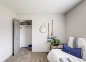Thumbnail 19 of 46 - a bedroom with a bed and a closet with a white door at Island Club Apartments, Columbus