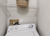 Thumbnail 25 of 46 - a white washer and dryer in a laundry room with a basket on top at Island Club Apartments, Columbus, 43235