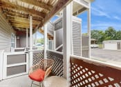 Thumbnail 3 of 46 - a covered porch with two chairs and a table at Island Club Apartments, Columbus, 43235