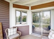 Thumbnail 8 of 35 - a porch with two chairs and a sliding glass door at Runaway Bay Apartments, Columbus