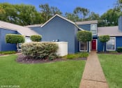 Thumbnail 13 of 24 - a blue house with a yard and a walkway at The Vale Apartments and Townhomes, Tennessee, 38018