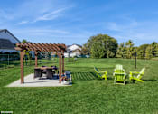 Thumbnail 31 of 46 - A backyard with a picnic table and chairs at Island Club Apartments, Columbus, OH