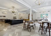Thumbnail 3 of 26 - A large, open-plan kitchen and dining area with a checkered floor and wooden furniture.