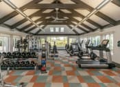 Thumbnail 31 of 35 - a gym with weights and cardio equipment in a large room with windows at Runaway Bay Apartments, Ohio, 43204