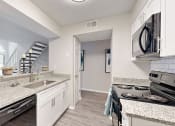 Thumbnail 18 of 24 - a kitchen with granite counter tops and stainless steel appliances at The Vale Apartments and Townhomes, Tennessee