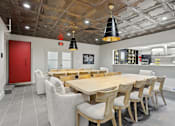 Thumbnail 8 of 26 - A dining room with a wooden table and chairs.