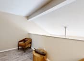 Thumbnail 21 of 24 - a living room with a chair and a window at The Vale Apartments and Townhomes, Tennessee, 38018