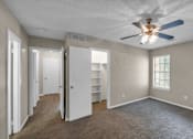 Thumbnail 7 of 19 - A room with a ceiling fan and a window with blinds.