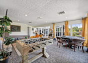 Thumbnail 3 of 24 - A room with a pool table and a chalkboard on the wall.