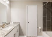 Thumbnail 24 of 24 - a bathroom with a sink and a shower and a mirror at The Vale Apartments and Townhomes, Cordova, 38018
